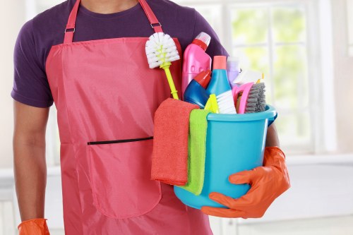 Cleaning technician preparing carpet cleaning equipment with safety focus