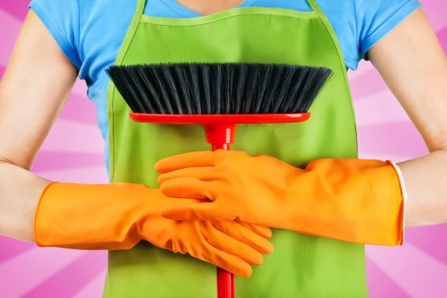 Technician wearing protective gloves and footwear during carpet cleaning